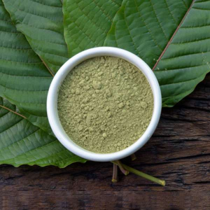 White Maeng Da Kratom Powder in Bowl on Kratom Leaves